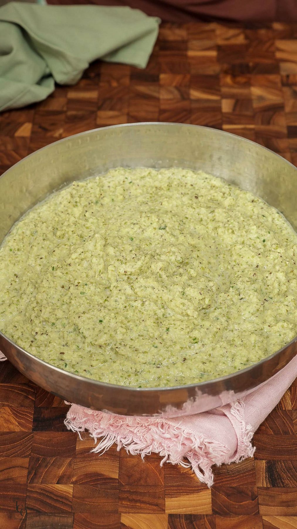 Coarse moong dal batter in a mixing bowl. 