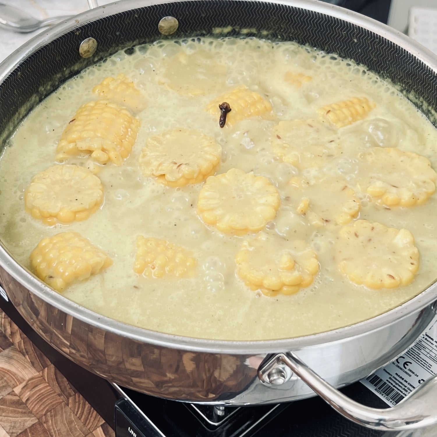 Corn cobs simmering in coconut milk.