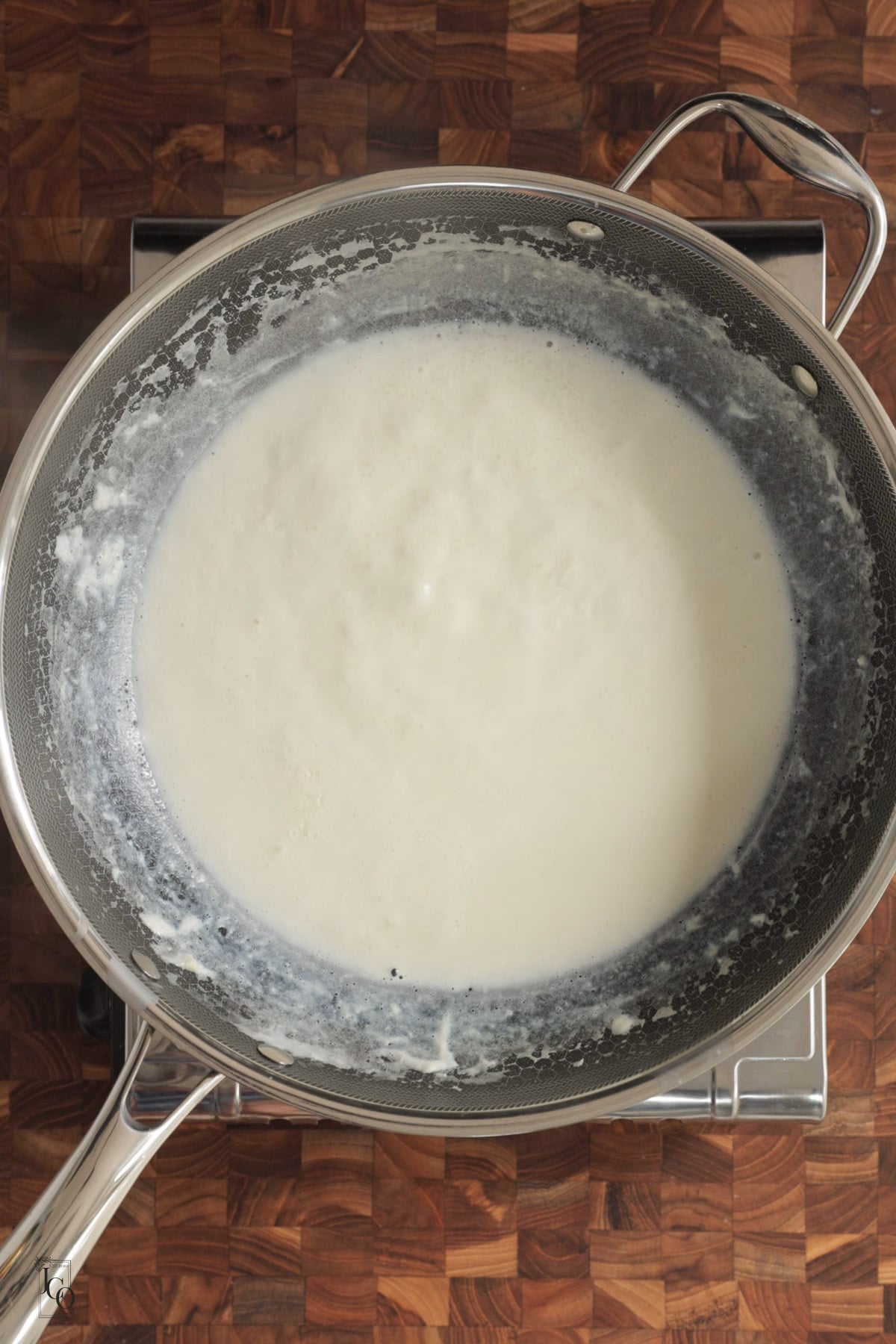 Thickened milk simmering in a pan.