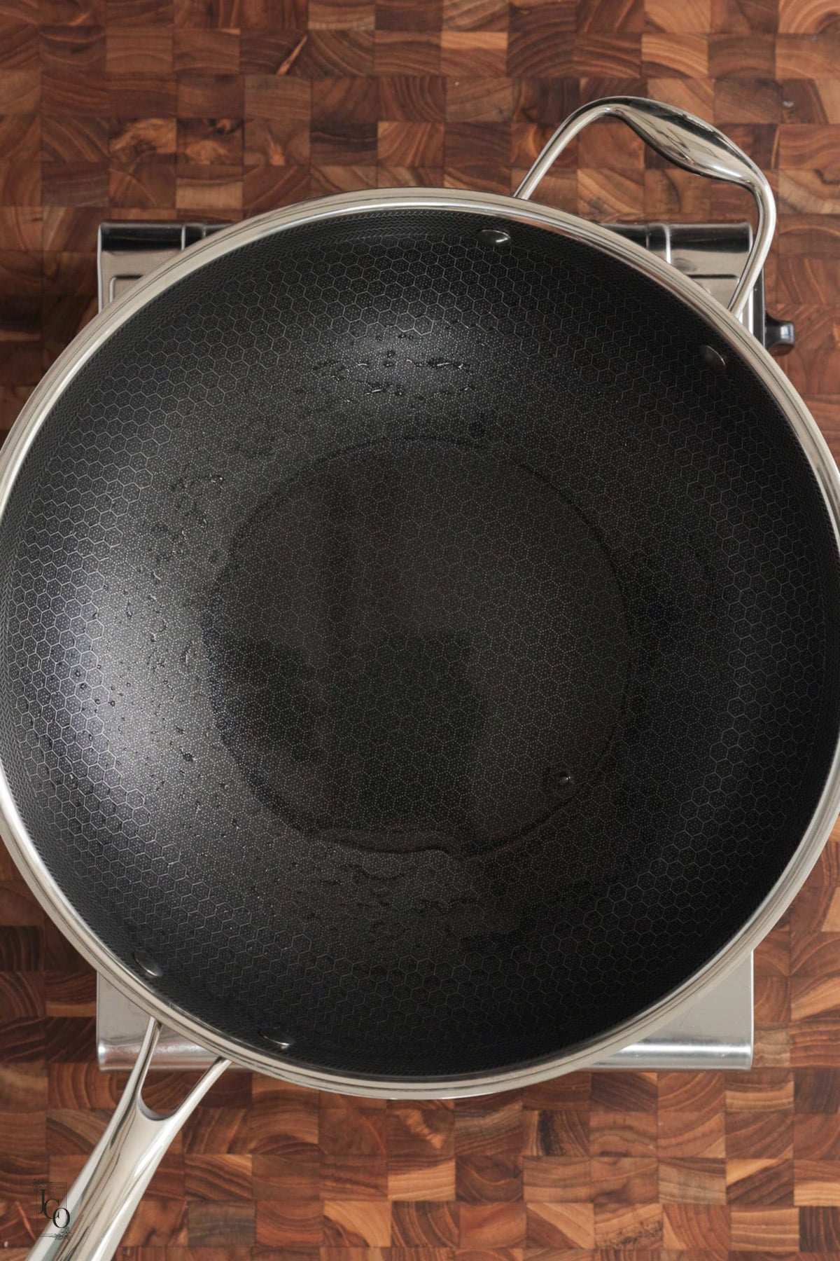 A wide mouth pan with a small amount of water.
