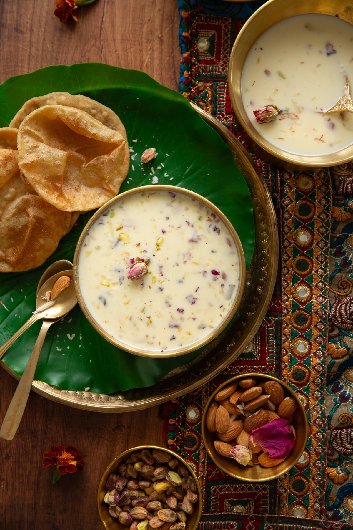 Basundi served with three puris on a plate.