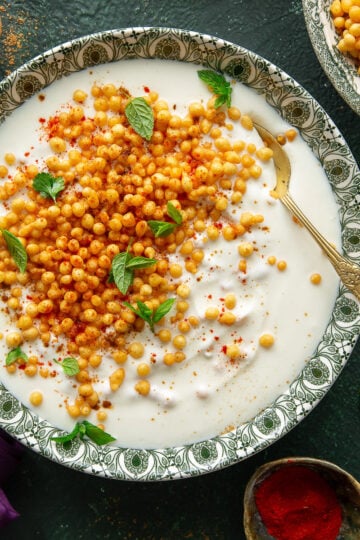 Boondi raita served in a bowl with a spoon.