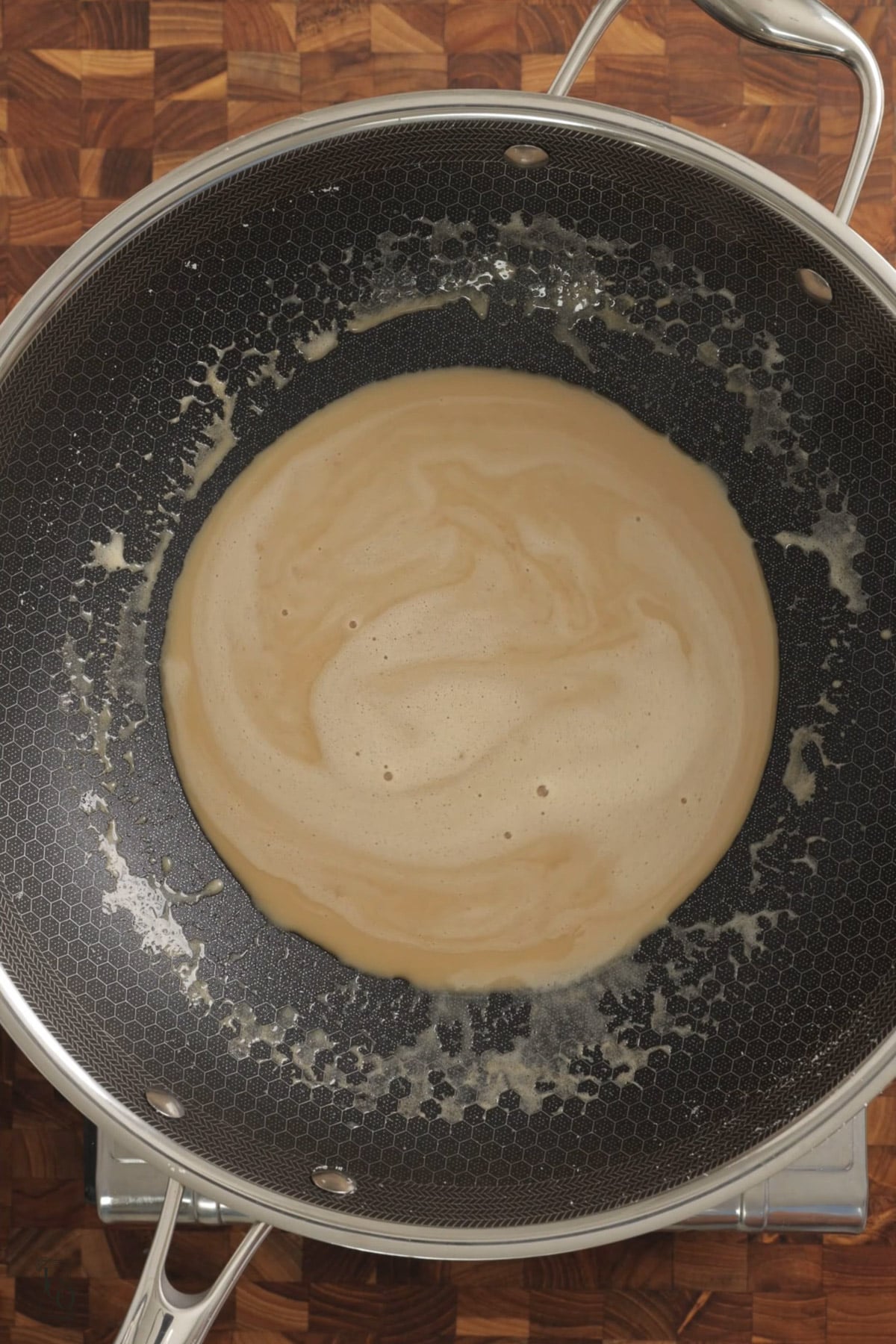 Brown thick milk mixture in a pan. 