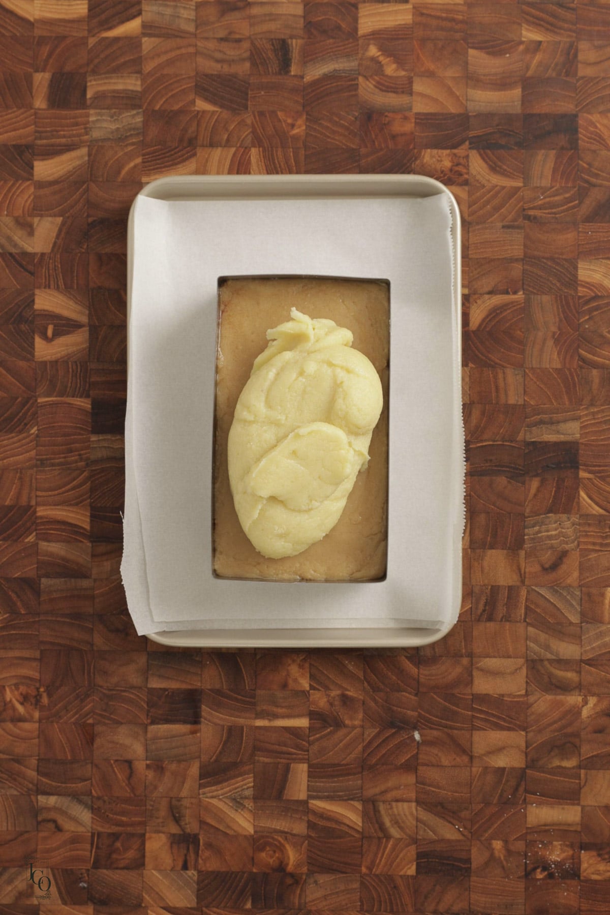 White barfi mixture spread on a brown barfi mixture in a tray. 