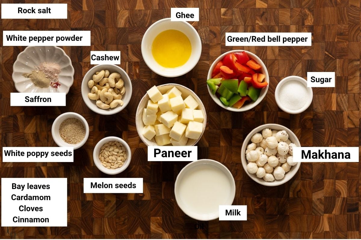 Paneer, Makhana, spices, ghee, milk and bell peppers in small white bowls.