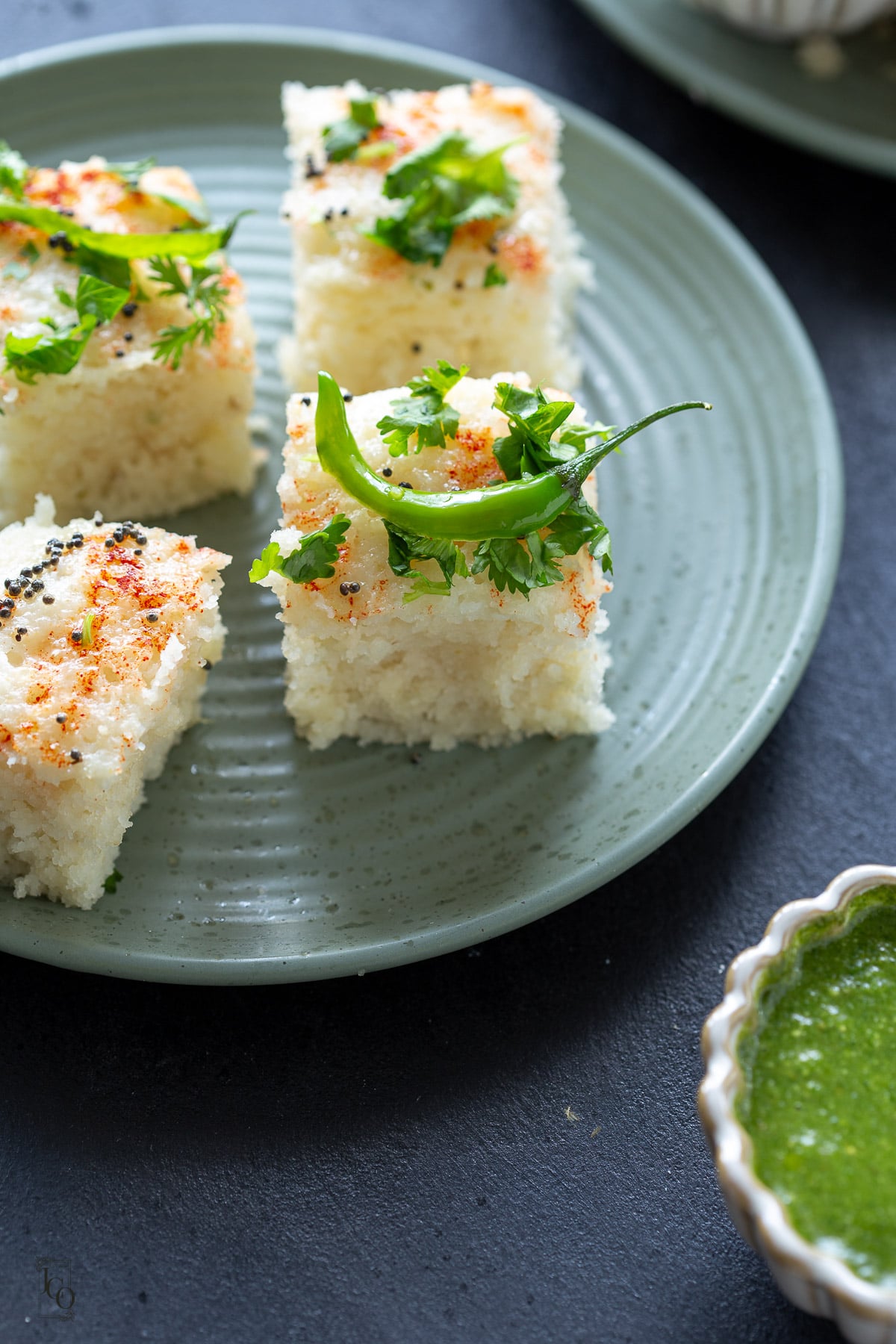 Four pieces of tall rava dhoklas served on a plate.