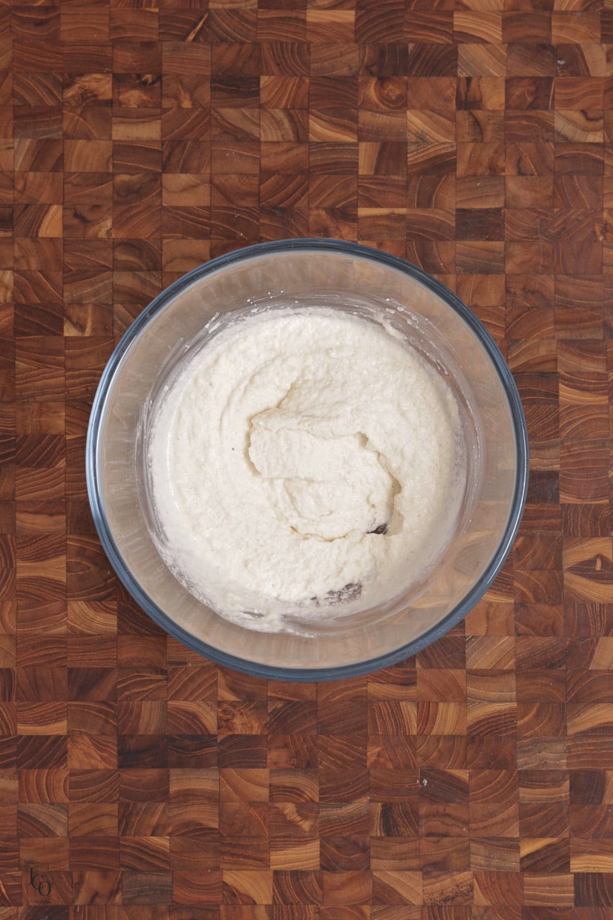 Semolina and yogurt batter in a clear mixing bowl.
