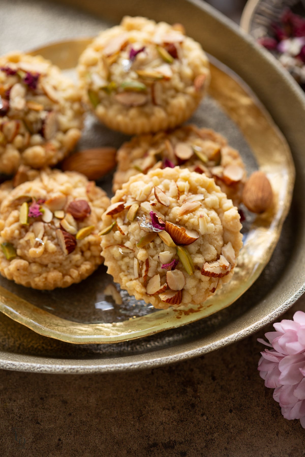 Badam halwa shortbread cookies served on a round gold rim glass tray.
