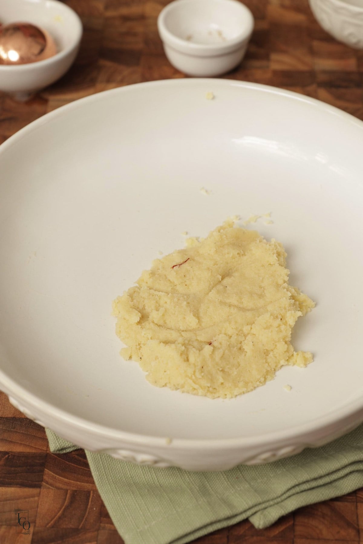 Mixture of almond marzipan in a small white bowl.