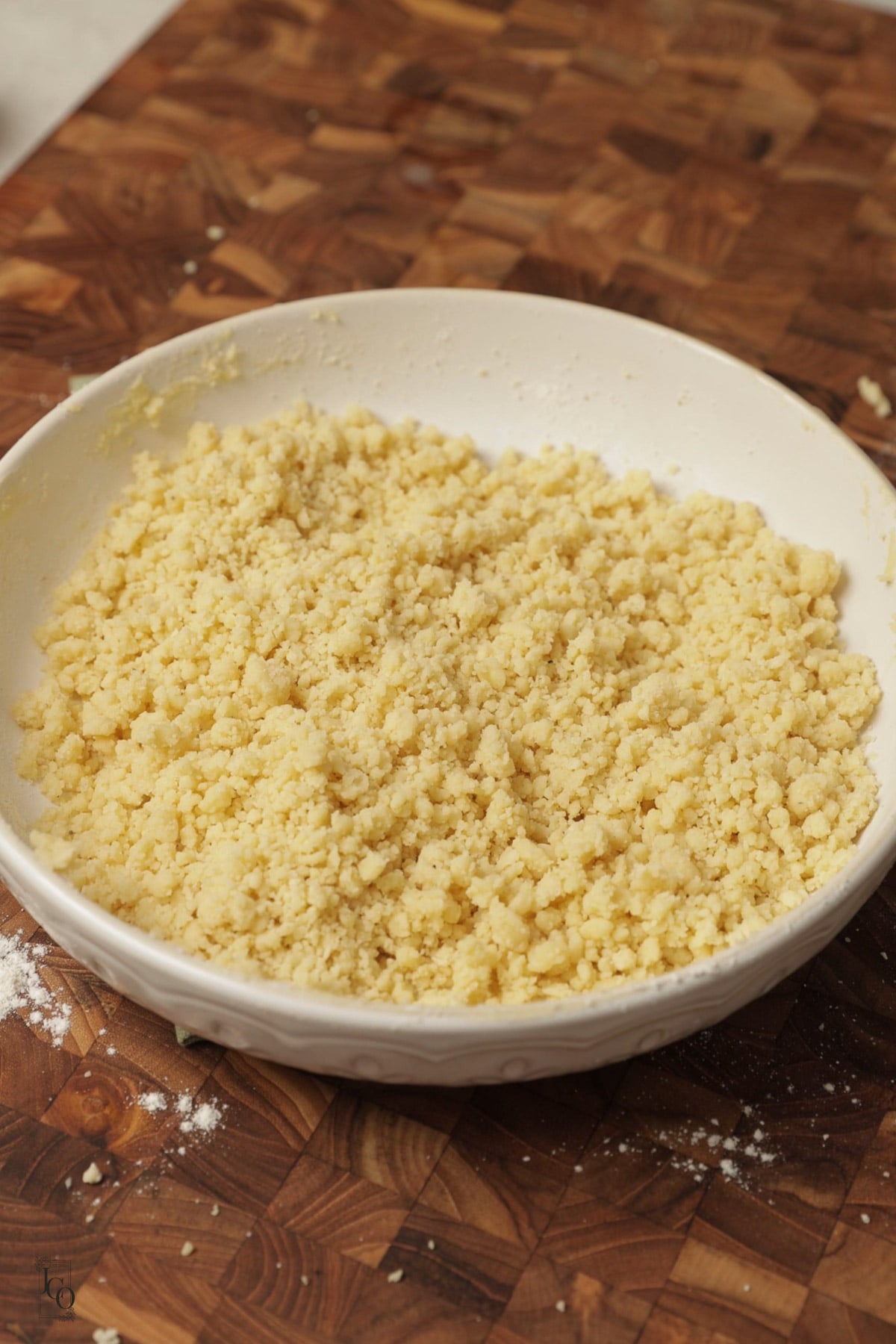 Crumbly shortbread dough in a bowl.